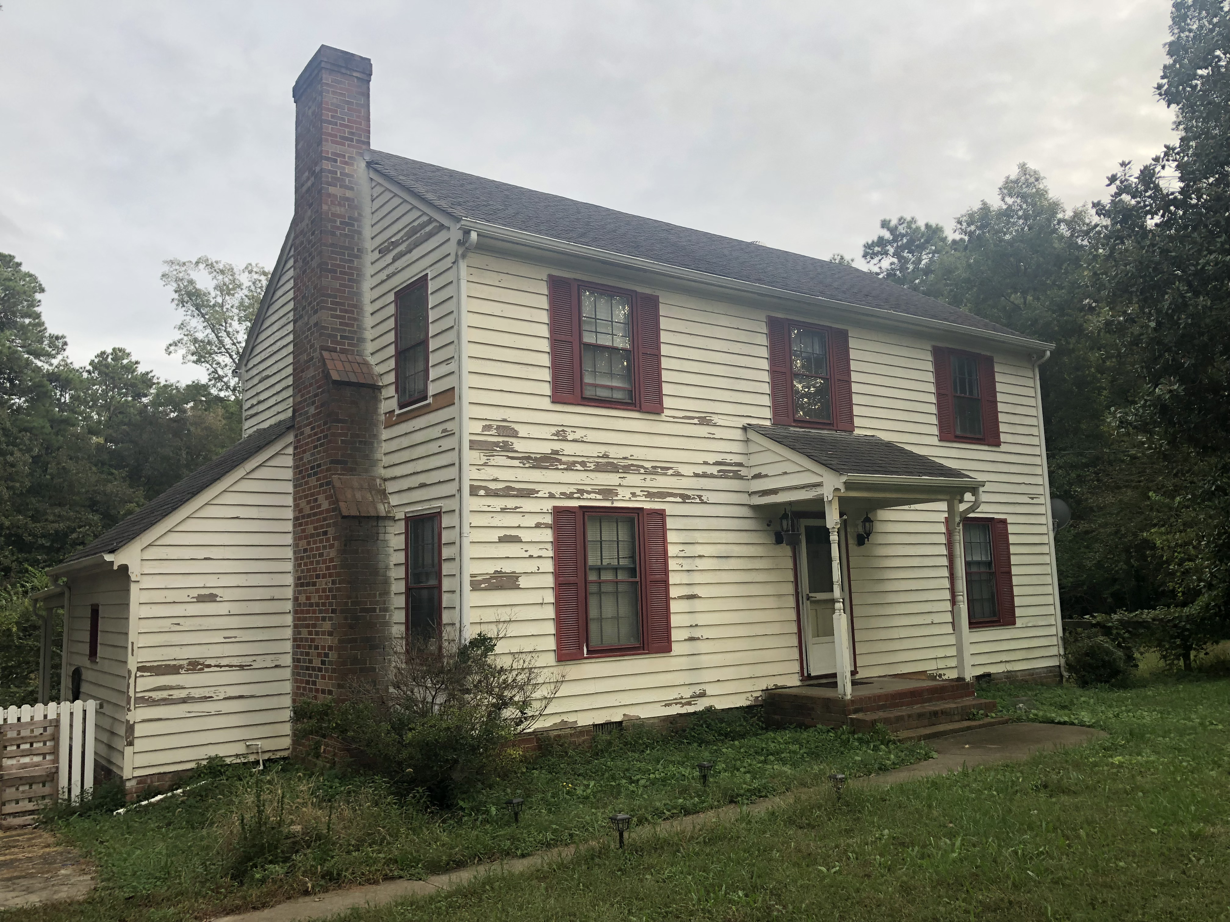 Exterior of house before painting — faded, peeling siding