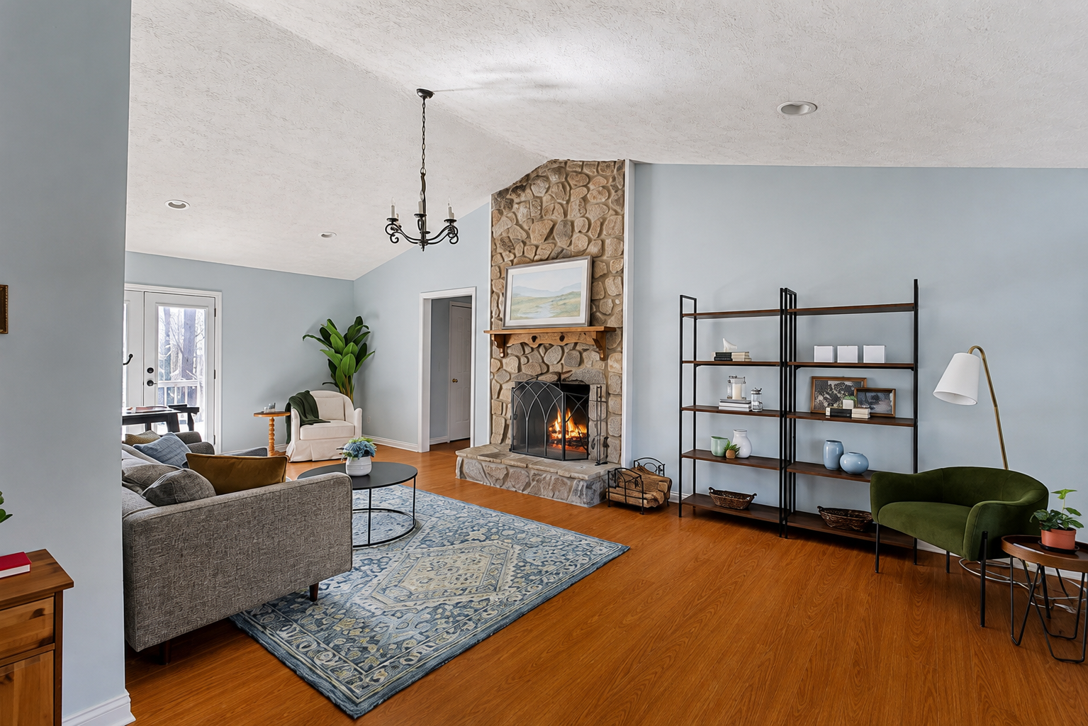 Freshly painted living room with cool blue walls and stone fireplace